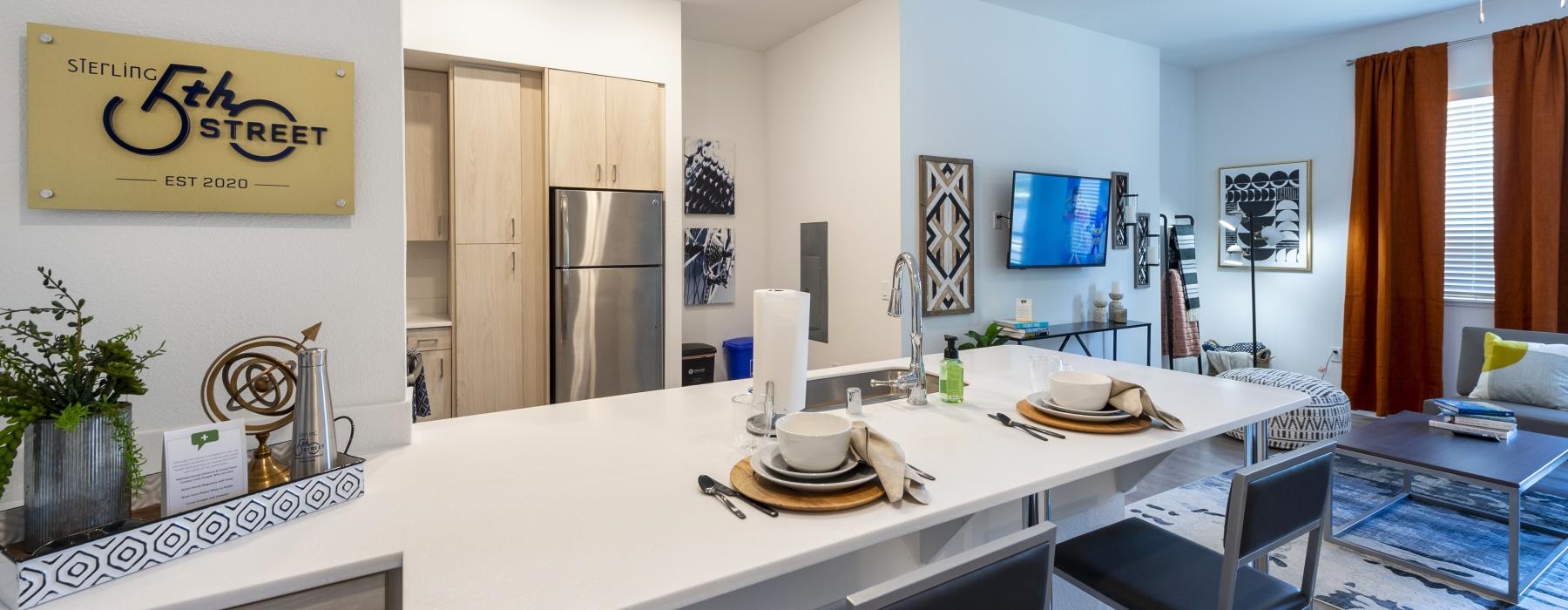 a kitchen with a large white table