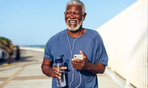 a man holding a water bottle while outdoors