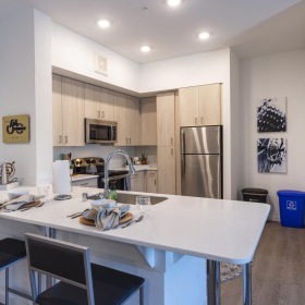 Spacious kitchens with thoughtful details a kitchen with a table and chairs
