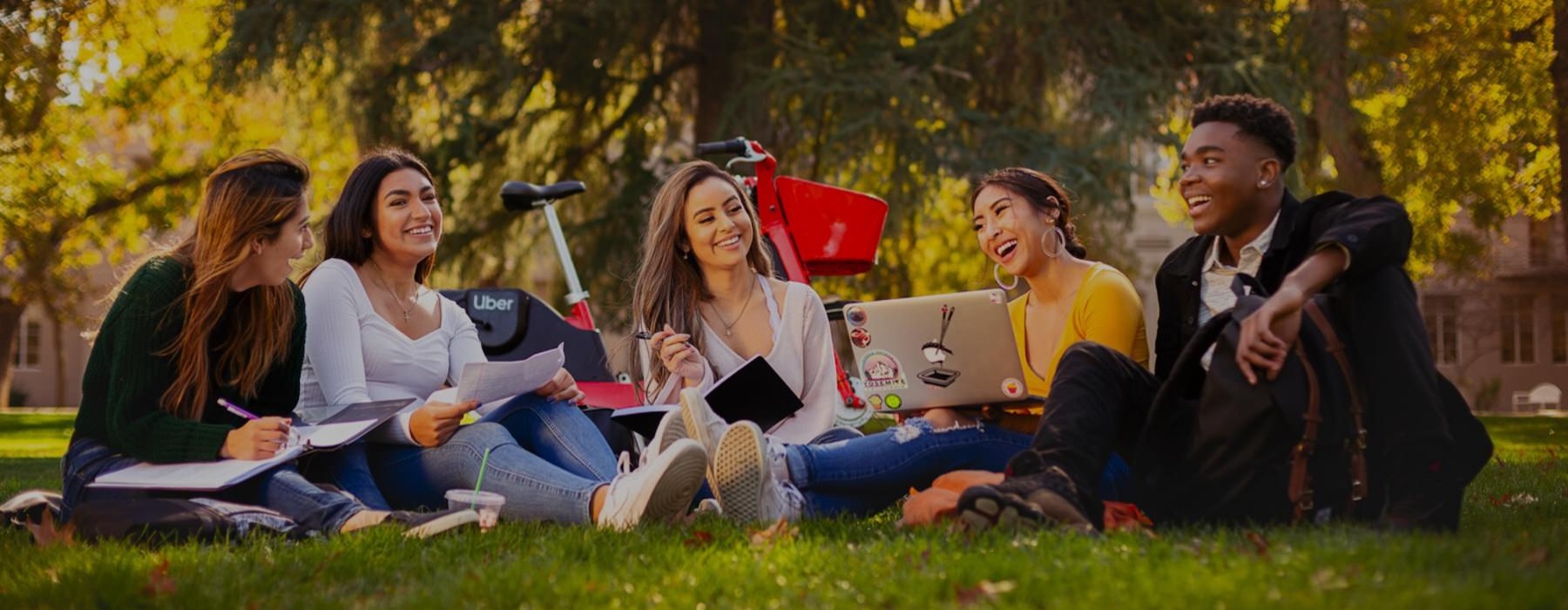 a group of students sitting in a park