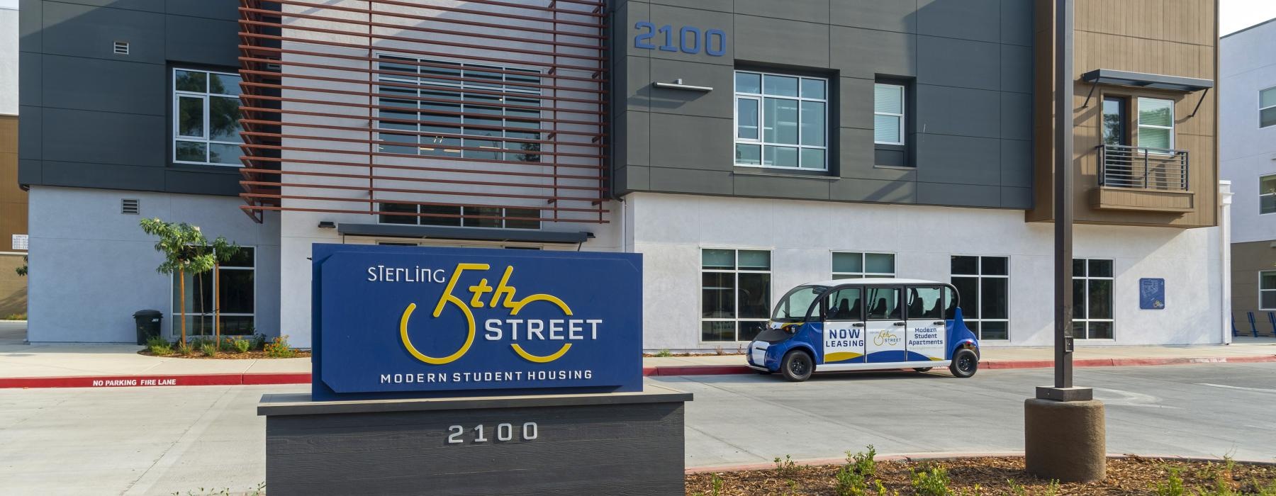 a blue van parked outside a building