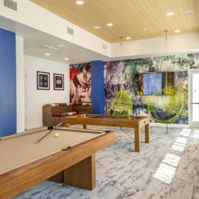 Settle into comfort at Sterling Fifth Street a room with a table and shelves